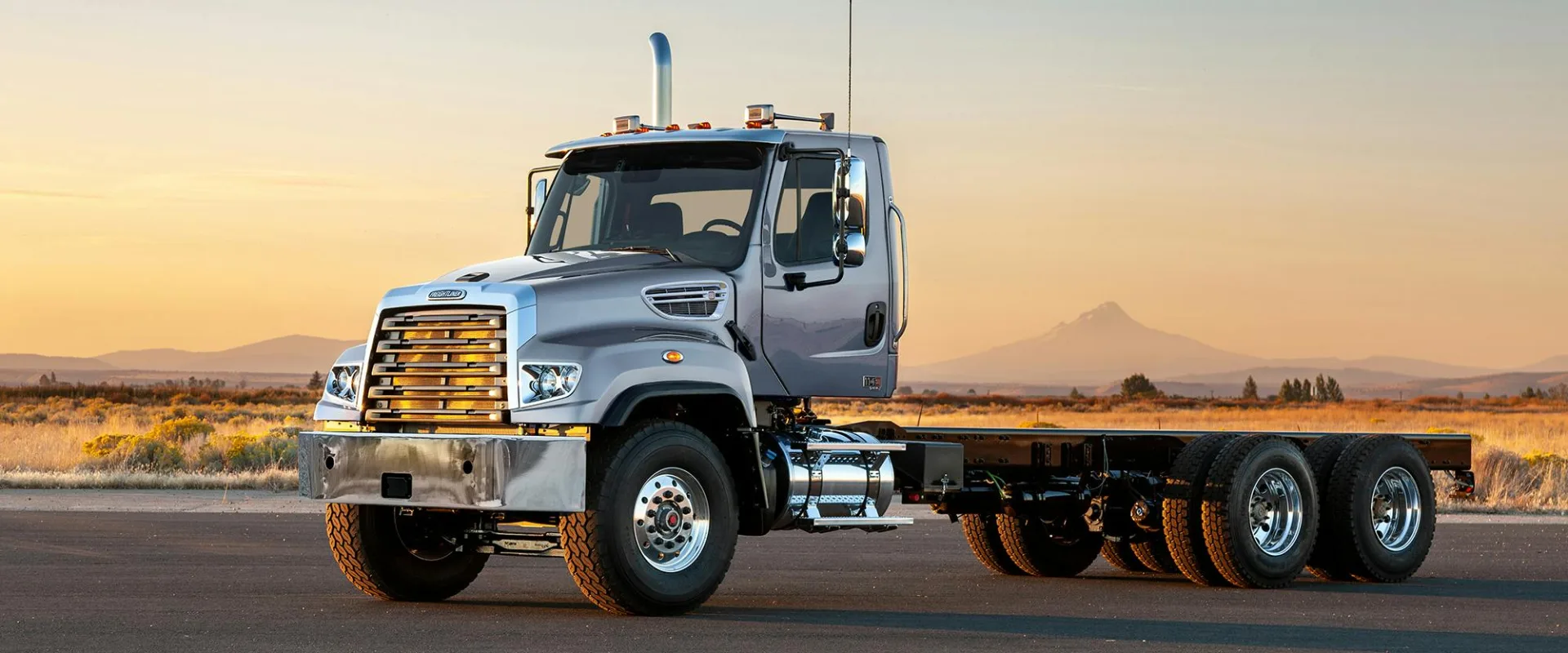 Freightliner 114SD Plus con plataforma al atardecer
